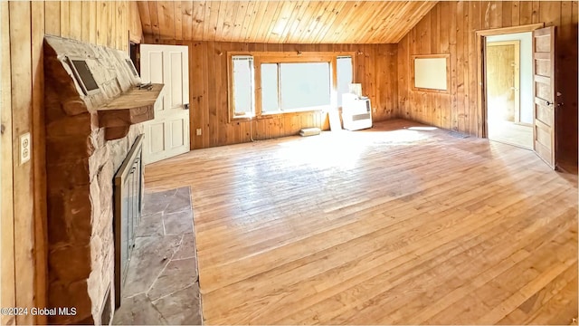 bonus room featuring wooden ceiling, lofted ceiling, wooden walls, and light wood-type flooring