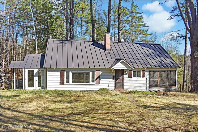 67 Adams Ln, Schroon, NY 12870 - view of front of home with a standing seam roof, a chimney, a front lawn, and metal roof