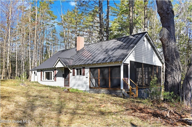 exterior space featuring a sunroom and a front yard