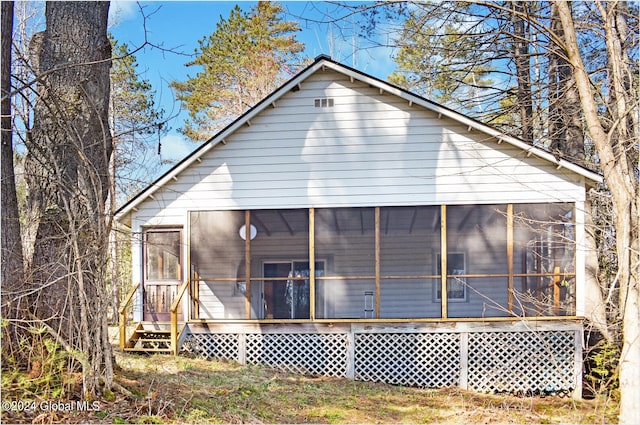 back of property featuring a sunroom