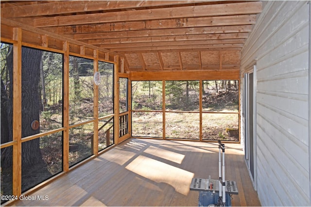 unfurnished sunroom featuring lofted ceiling