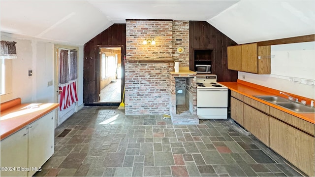 kitchen featuring wood walls, lofted ceiling, and white range with electric cooktop