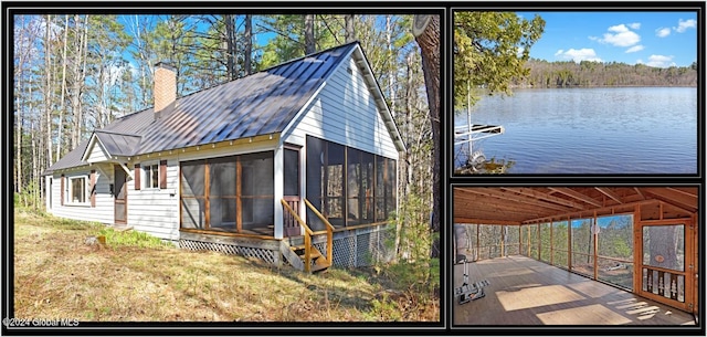 exterior space with a sunroom and a water view