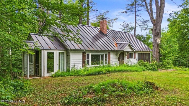 67 Adams Ln, Schroon, NY 12870 - view of front of property with a standing seam roof, a chimney, and metal roof