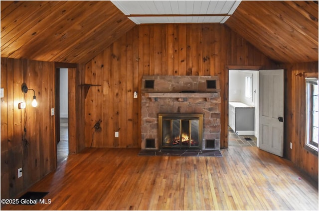67 Adams Ln, Schroon, NY 12870 - unfurnished living room with vaulted ceiling, wooden walls, hardwood / wood-style flooring, wooden ceiling, and a fireplace