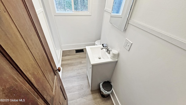 67 Adams Ln, Schroon, NY 12870 - bathroom with wood finished floors, baseboards, and vanity