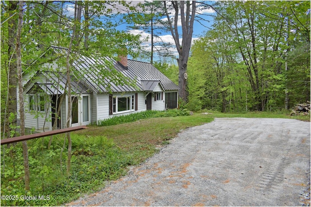 67 Adams Ln, Schroon, NY 12870 - view of property exterior featuring a standing seam roof, metal roof, and a chimney