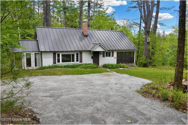 67 Adams Ln, Schroon, NY 12870 - view of front of home featuring a chimney, a standing seam roof, a front lawn, and metal roof