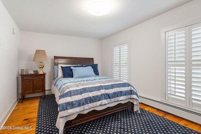 bedroom featuring a baseboard radiator and light wood-type flooring