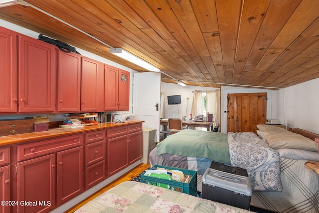 bedroom featuring vaulted ceiling, wooden ceiling, and light hardwood / wood-style flooring