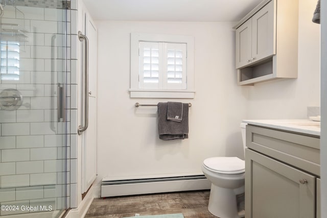 bathroom with toilet, an enclosed shower, wood-type flooring, a baseboard radiator, and vanity