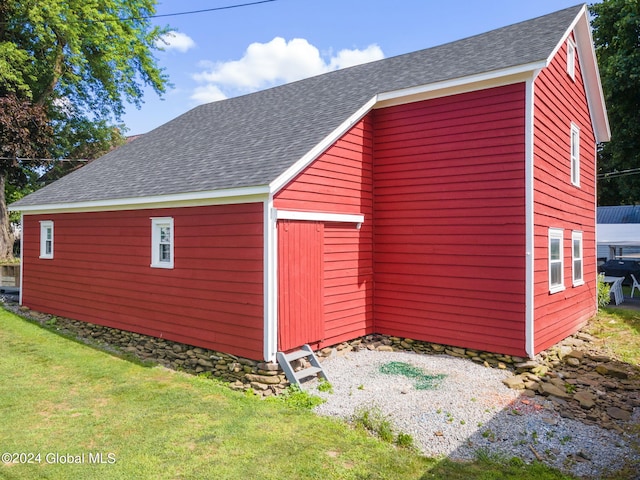 view of outbuilding with a yard