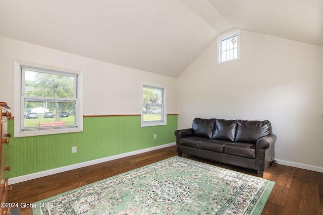 living room with dark wood-type flooring, vaulted ceiling, and plenty of natural light