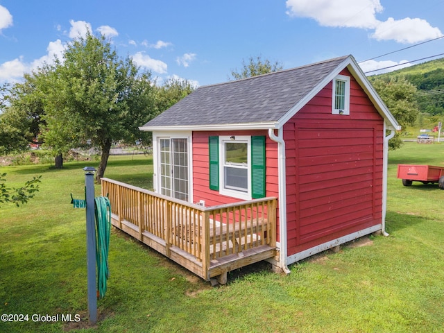 view of outbuilding featuring a lawn