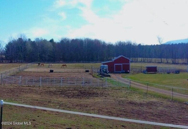 view of yard with a rural view and an outdoor structure