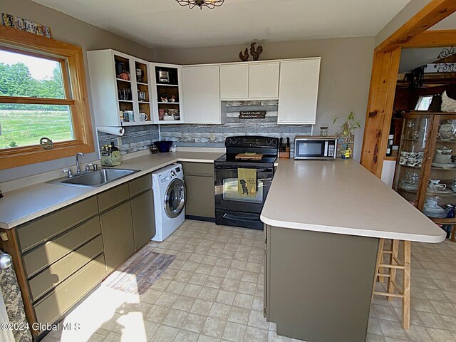 kitchen with gray cabinetry, sink, black / electric stove, washer / dryer, and white cabinetry