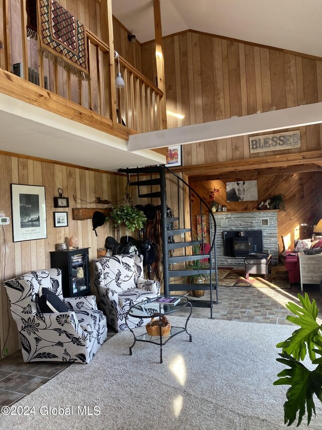 carpeted living room with wood walls and vaulted ceiling