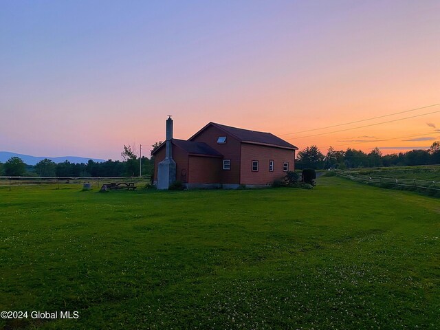 exterior space with a rural view and a lawn