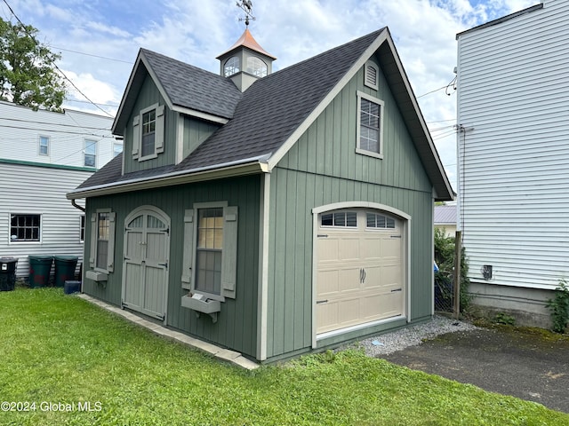 garage featuring a yard