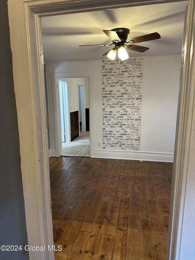 spare room with wood-type flooring and ceiling fan