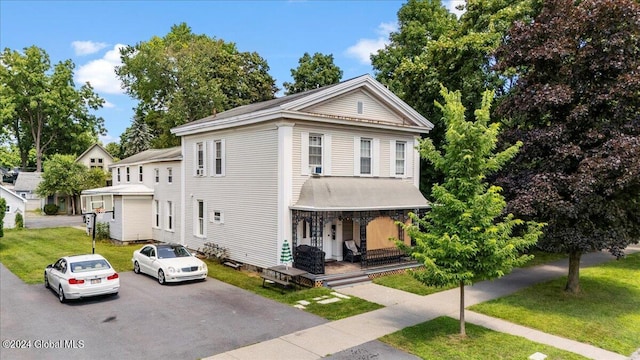 107-109 Lake Ave, Saratoga Springs, Inside, NY 12866 - view of front of home featuring aphalt driveway, covered porch, and a front lawn