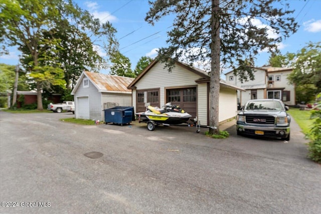 view of front facade with a garage and an outbuilding