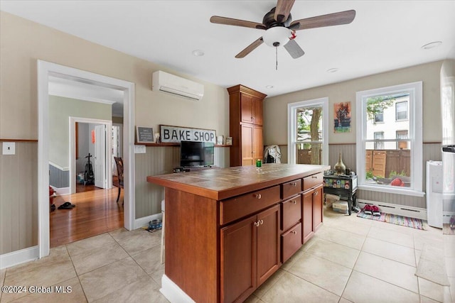 107-109 Lake Ave, Saratoga Springs, Inside, NY 12866 - kitchen with an AC wall unit, ceiling fan, wainscoting, tile countertops, and light tile patterned flooring