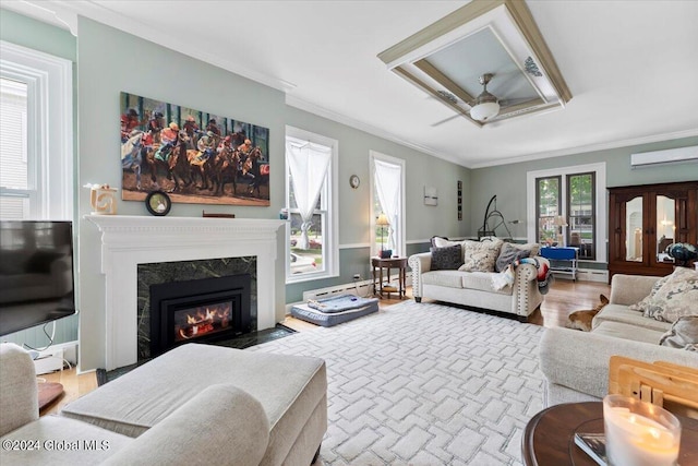 living room featuring ceiling fan, hardwood / wood-style floors, ornamental molding, french doors, and a baseboard heating unit