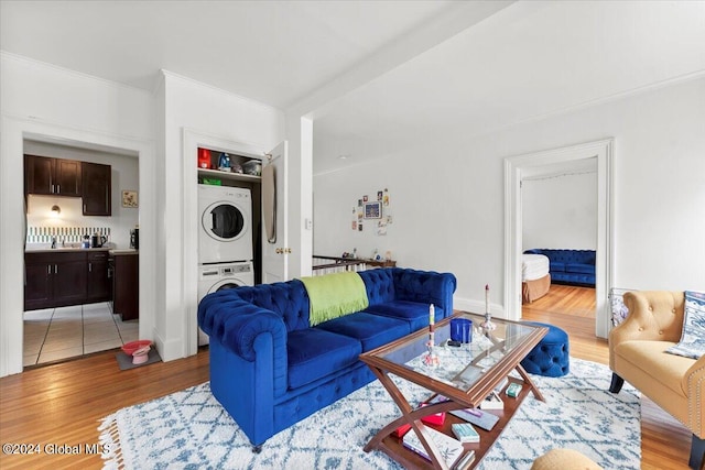 living room with stacked washer / dryer and light tile patterned floors