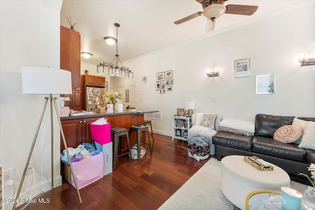 living room featuring dark wood-type flooring, crown molding, and ceiling fan