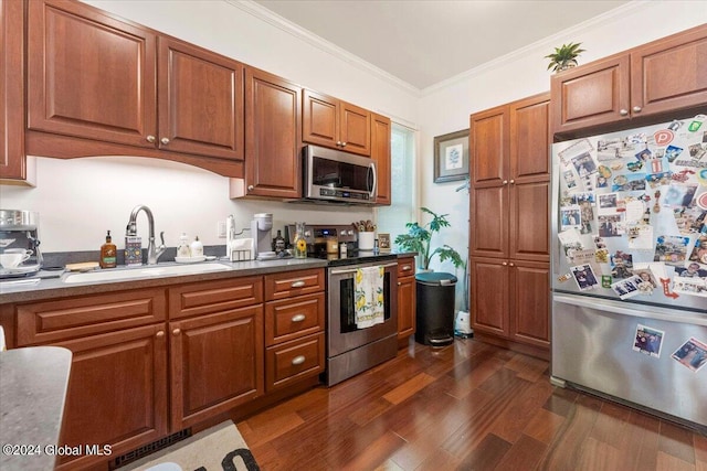 kitchen with dark hardwood / wood-style floors, crown molding, appliances with stainless steel finishes, and sink