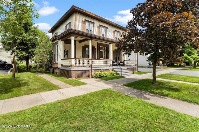 view of front of house with a porch and a front lawn