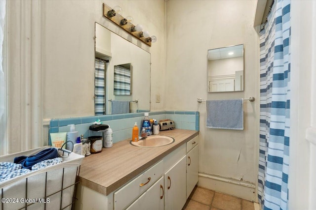 bathroom featuring vanity, decorative backsplash, and tile patterned flooring