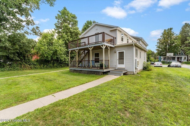 view of front of house with a balcony and a front yard