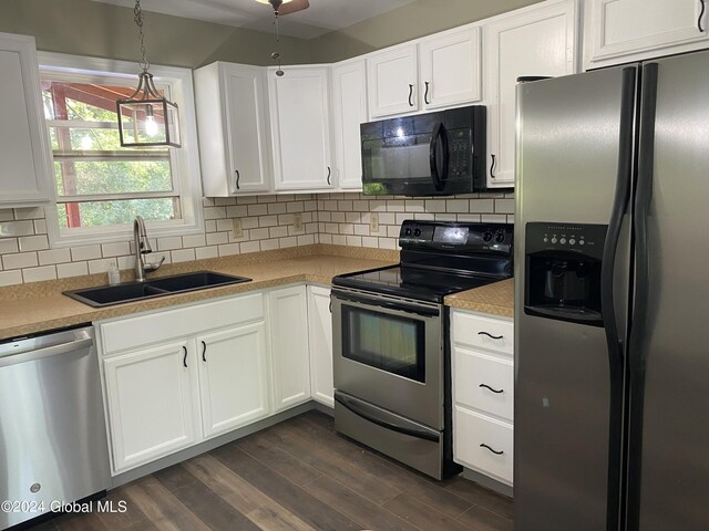 kitchen featuring appliances with stainless steel finishes, dark hardwood / wood-style floors, decorative backsplash, and sink