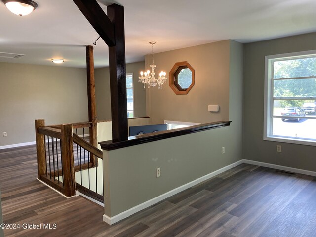 interior space featuring dark hardwood / wood-style floors, decorative light fixtures, and an inviting chandelier