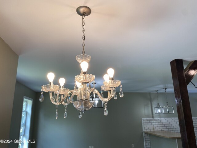 interior details featuring an inviting chandelier