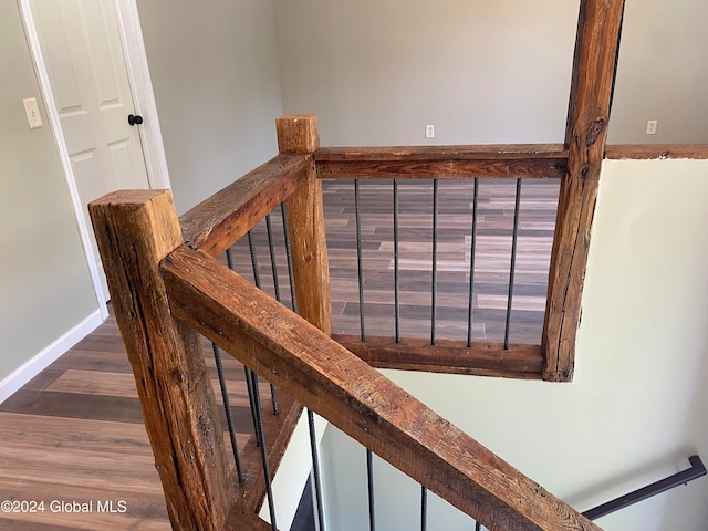 stairway with hardwood / wood-style floors