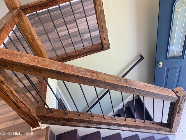 staircase with wood-type flooring