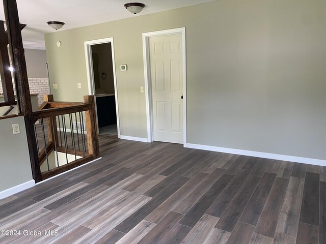 spare room featuring dark hardwood / wood-style flooring