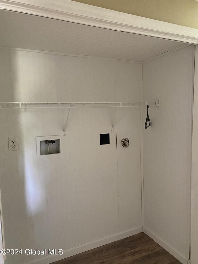 clothes washing area featuring dark hardwood / wood-style floors and washer hookup