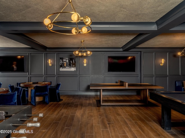 recreation room with beam ceiling, a chandelier, wood tiled floor, and a decorative wall