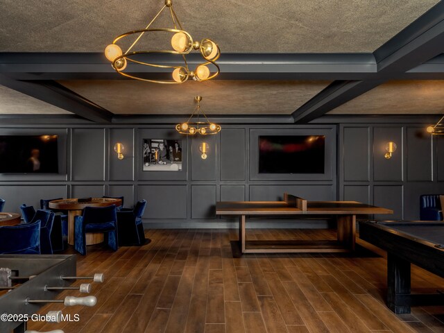 playroom with a chandelier, a decorative wall, and wood tiled floor