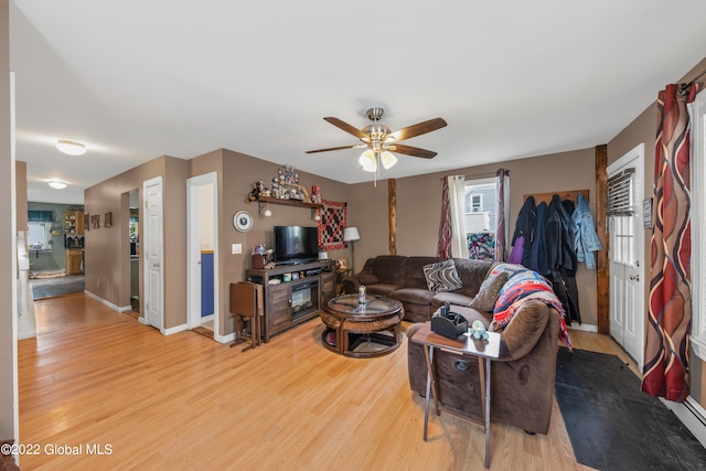 living room with light hardwood / wood-style floors and ceiling fan