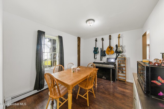 dining room featuring dark wood-type flooring and baseboard heating