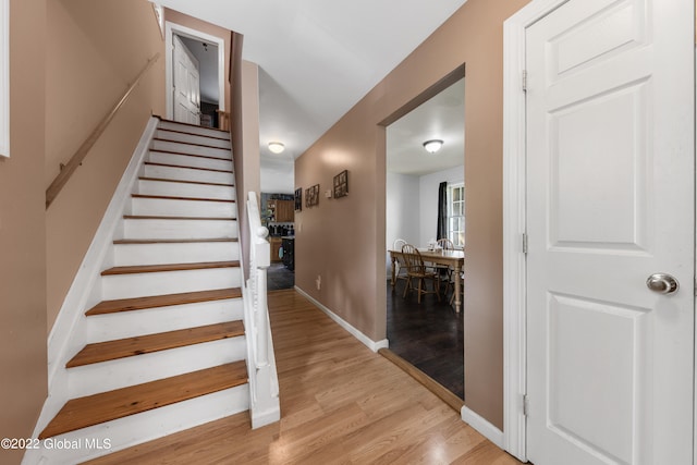 stairway featuring light hardwood / wood-style floors