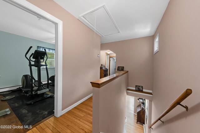 interior space featuring a baseboard radiator, light hardwood / wood-style flooring, and plenty of natural light