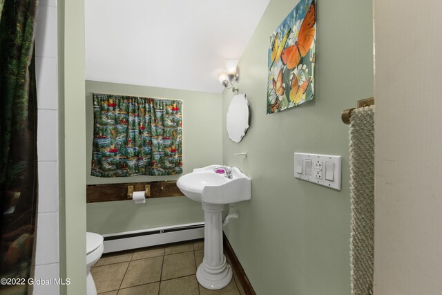 bathroom featuring tile patterned flooring, toilet, and a baseboard radiator