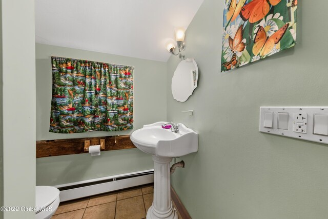 bathroom featuring toilet, tile patterned floors, and a baseboard heating unit