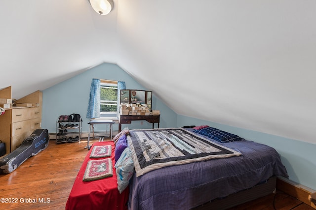 bedroom featuring hardwood / wood-style flooring and lofted ceiling